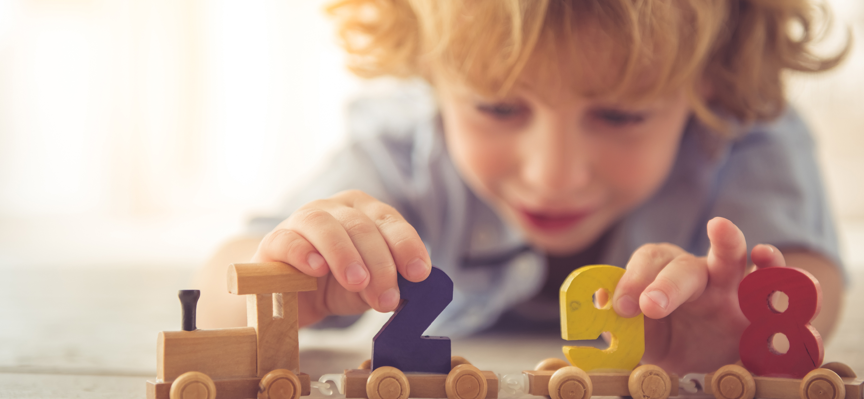 Child playing with numbered blocks